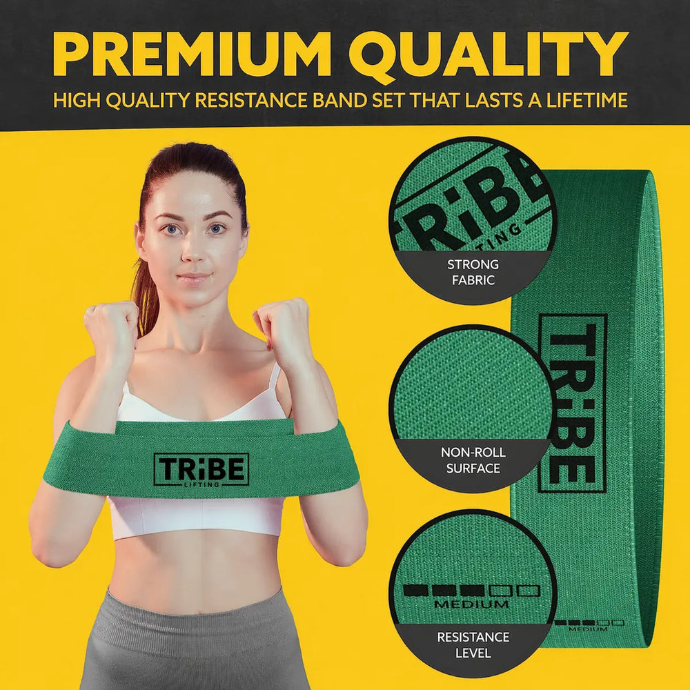 Woman holding the green medium resistance band from the Tribe Lifting fabric resistance bands set of 5 with strong fabric and non-roll surface details