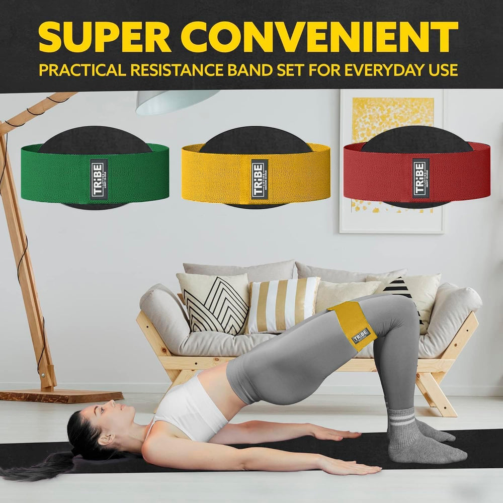 Woman demonstrating a glute bridge with the Tribe Lifting red yellow and green premium resistance bands set 3 during a home workout
