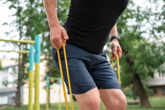 man doing strength exercises with resistance bands