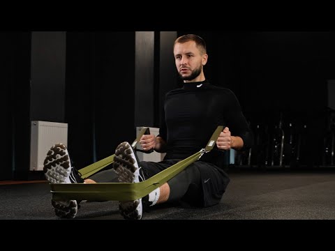 Tribe Lifting green resistance bands promo video showing a man using the bands for seated row exercises and guided workout instructions.