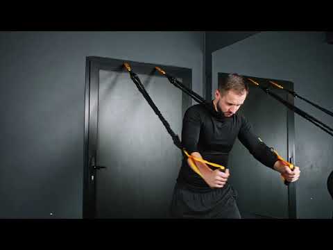Man using Tribe Lifting tube resistance bands with handles and door anchor for a chest fly