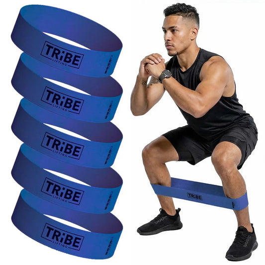 Man demonstrating a squat with the blue heavy fabric resistance band from the Tribe Lifting resistance bands set of 5