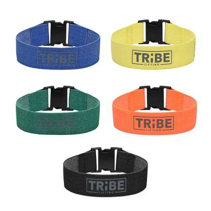 Set of five Tribe Lifting fabric resistance bands with adjustable buckles in blue, yellow, green, orange, and black.