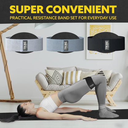 Woman demonstrating a glute bridge with the Tribe Lifting gray and black premium resistance bands set 3 during a home workout