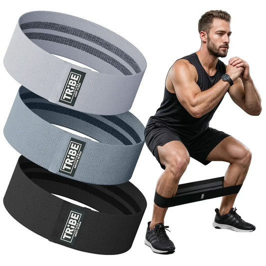 Man demonstrating a squat with the Tribe Lifting gray and black premium resistance bands set 3