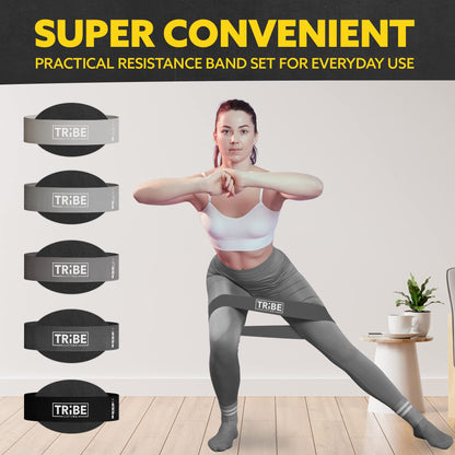 Woman demonstrating a side lunge with the gray fabric resistance band from the Tribe Lifting resistance bands set of 5 at home