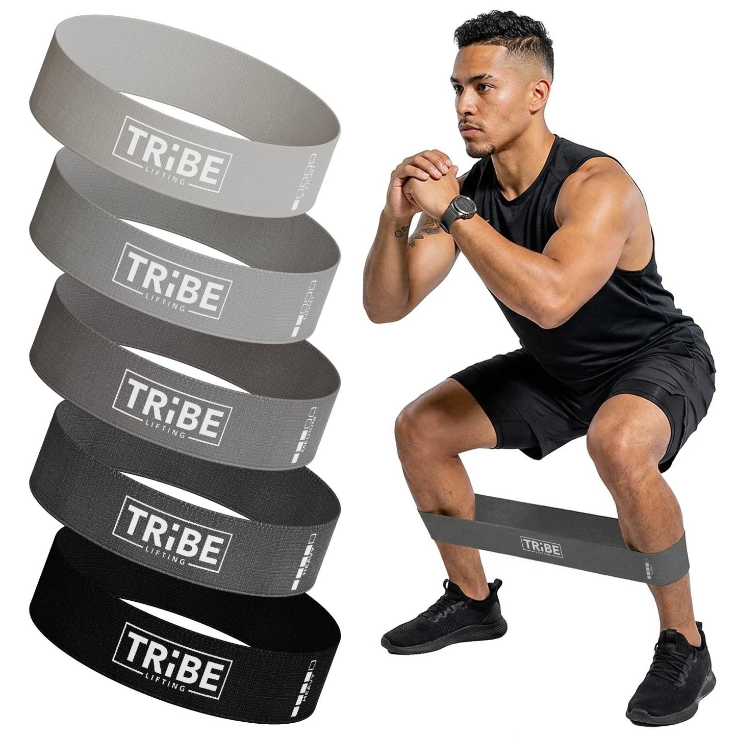 Man demonstrating a squat with the gray fabric resistance band from the Tribe Lifting resistance bands set of 5