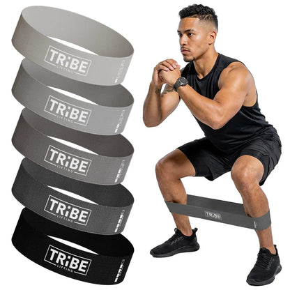 Man demonstrating a squat with the gray fabric resistance band from the Tribe Lifting resistance bands set of 5