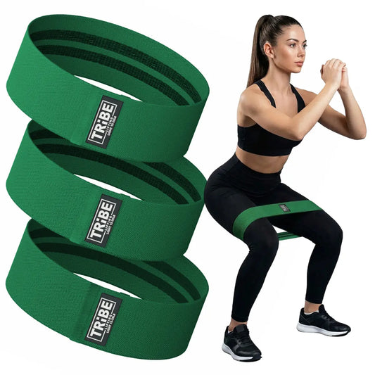 Man demonstrating a squat with the Tribe Lifting green premium resistance bands set 3