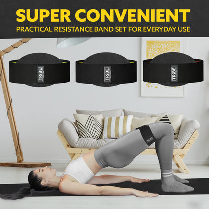 Woman demonstrating a glute bridge with the Tribe Lifting premium resistance bands set 3 during a home workout