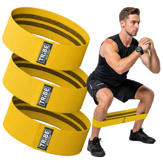 Man demonstrating a squat with the Tribe Lifting yellow premium resistance bands set 3