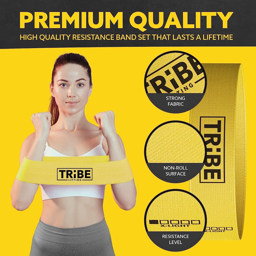 Woman holding the yellow x-light resistance band from the Tribe Lifting fabric resistance bands set of 5 with premium fabric and non-roll surface details
